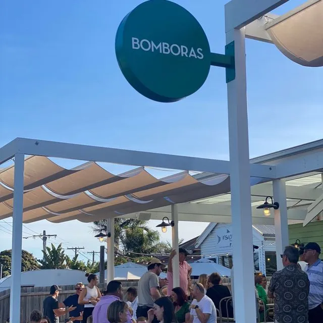 Bomboras outdoor dining area with patrons enjoying sunny day.
