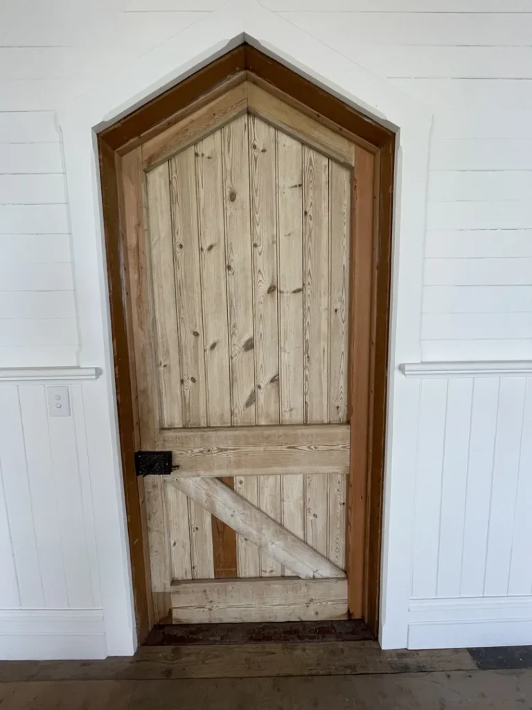 Wooden barn door with diagonal brace design.