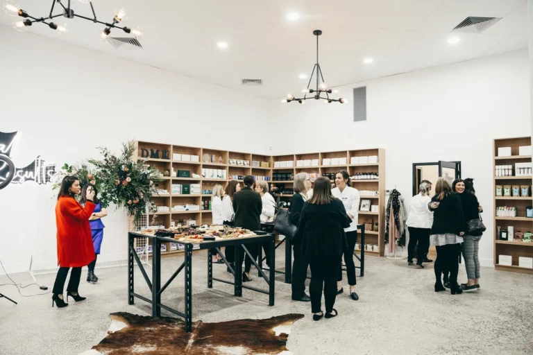 Guests networking at modern boutique event with refreshments.